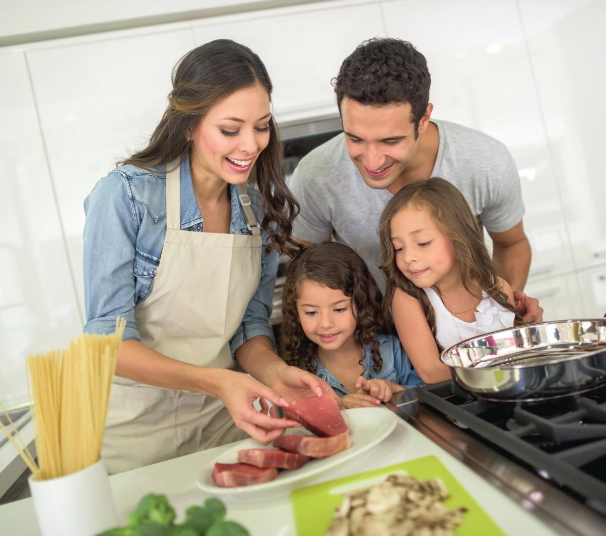 Happy family cooking dinner together | Bashas